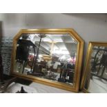 A gilt framed bevel edged over mantel mirror.