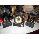 A black marble 3 piece clock garniture, in working order.