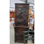 A lead glazed corner cabinet.