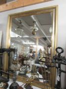 A large bevel edged mirror in gilded frame, 107 x 138 cm.