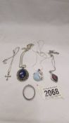 Three silver pendants set coloured stones,