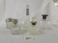 4 scent bottles with silver collars and a hair pot with silver top.