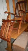 A folding wooden outdoor chair with brass fittings. (Collect only).