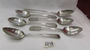Four matching table spoons, one other and a long handled table spoon, approximately 450 grams.