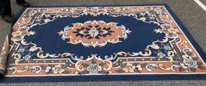 A large blue & cream/salmon living room carpet (approximately 190cm x 280cm)