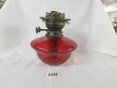 A genuine ruby glass drop in oil lamp font with original Veritas burner, in good condition.