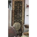 A woven backed carpet runner, 230 x 80 cm.