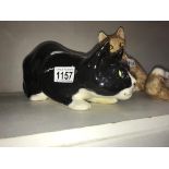 A signed Winstanley black & white crouching cat with glass eyes, size 5,