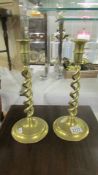 A pair of brass candlesticks with barley twist stems.