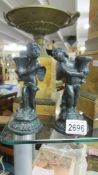A pair of early 20th century spelter angel candlesticks.