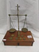 A set of brass postal scales on drawer base.