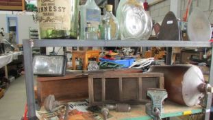 Two shelves of miscellaneous bottles, tools, vice etc.