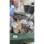 A box of stainless steel kitchen ware.