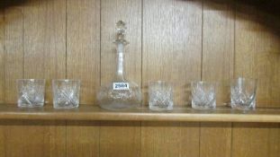 A decanter and 5 whisky tumblers.