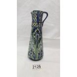 A Moorcroft Macintyre Florian ware jug, a/f damage to spout and crazing to glaze). 20cm tall.