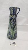 A Moorcroft Macintyre Florian ware jug, a/f damage to spout and crazing to glaze). 20cm tall.