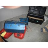 Three fuel cans, battery charger and tool box.