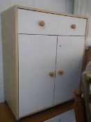 A white one drawer, two door cabinet.
