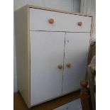 A white one drawer, two door cabinet.