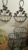 Three wrought iron garden baskets and 2 wall hanging baskets.