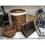 A wicker linen basket, shopping basket & 2 others.