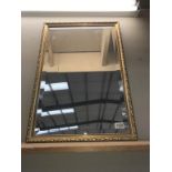 A gilt framed bevel edged mirror.