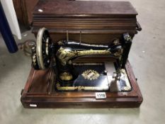 A cased Singer sewing machine (Collect only)