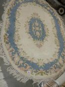 An oval Chinese rug.