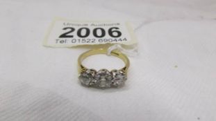 A 14ct gold three stone diamond ring, (1 carat diamonds in total,