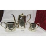 A three piece silver plate tea set.