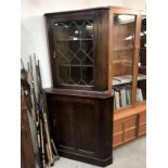 A dark oak corner cabinet with leaded glass door, 90 cm wide x 179 cm high.