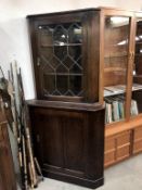 A dark oak corner cabinet with leaded glass door, 90 cm wide x 179 cm high.