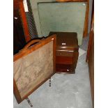 A folding table, a magazine rack and a tapestry fire screen.