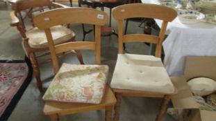 A pair of pine kitchen chairs.