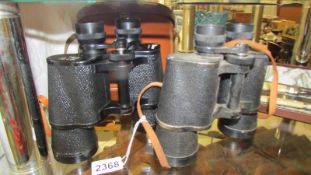 Two pair of binoculars - one cased Pathescope 10 x 50 and uncased Silraft 10 x 50.