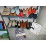 Two shelved of used shoes.