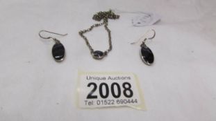 A silver pendant with matching earrings (possibly set Blue John).