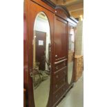 An Edwardian mahogany inlaid combination wardrobe.