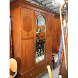 A mahogany inlaid single mirrored door wardrobe.