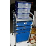 A modern filing chest on castors and a three drawer plastic chest.