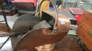 A copper coal scuttle.