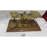 A set of brass letter scales with weights.