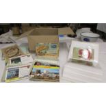 Two small albums of postcards and a box of postcards.