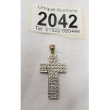A gold and diamond cross pendant. ****Condition report**** In very good condition.