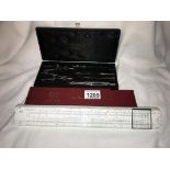 A cased set of draughtsman tools & a cased PIC slide rule
