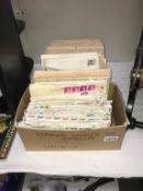 A box of UK stamps on envelopes & a box of Foreign stamps on envelopes