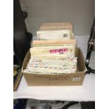 A box of UK stamps on envelopes & a box of Foreign stamps on envelopes