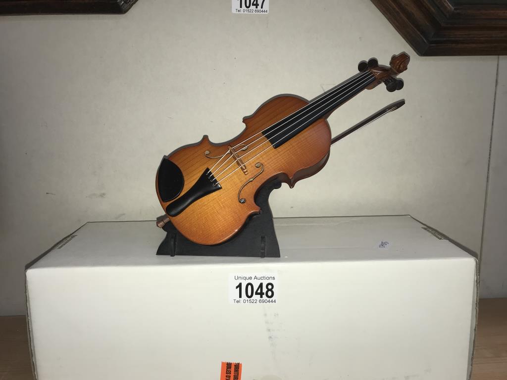 A musical double bass on stand - length approximately 25cm