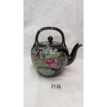 A Chinese hand painted tea pot.