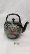 A Chinese hand painted tea pot.